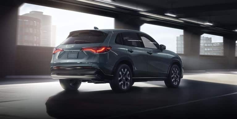 2027 Honda HR-V EX-L in Nordic Forest Pearl three quarter rear view driving through a city tunnel (Subcompact Crossover SUV).